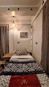 a small bedroom with a bed and a table at Horus key Nile View in Aswan