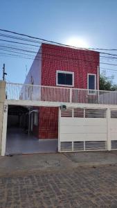 a red brick building with a balcony on it at Apt perto do shopping in Petrolina