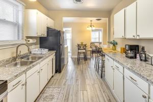 a kitchen with white cabinets and a black refrigerator at Pueblo Perfection A Quiet Colorado Adventure! in Pueblo