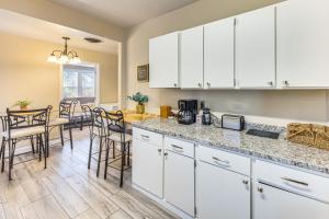 a kitchen with white cabinets and a dining room at Pueblo Perfection A Quiet Colorado Adventure! in Pueblo +16 photos