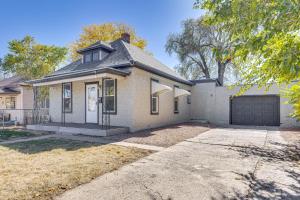 a white brick house with a garage at Pueblo Perfection A Quiet Colorado Adventure! in Pueblo