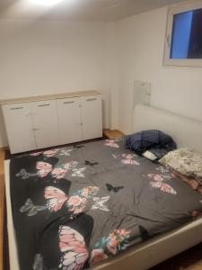 a bedroom with a bed with a blanket on it at Small apartment suitable for craftsmen in Westerburg