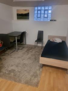 a bedroom with a bed and a table and chairs at Small apartment suitable for craftsmen in Westerburg