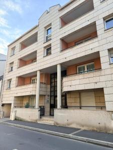 a building with columns on the side of a street at Spacious home near Canal and Stadium with Wifi in Reims