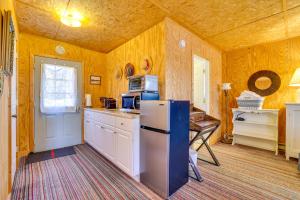 eine Küche mit einem Kühlschrank und einem Tisch darin in der Unterkunft Hike, Ski and Golf Water-View Lake Winola Retreat! in Factoryville
