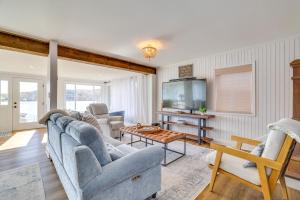 a living room with couches and a tv at Scenic Waterfront Home with Dock on Lake Winola! in Factoryville