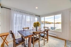 a dining room with a table and chairs and a window at Scenic Waterfront Home with Dock on Lake Winola! in Factoryville