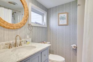 a bathroom with a sink and a toilet and a mirror at Scenic Waterfront Home with Dock on Lake Winola! in Factoryville +22 photos
