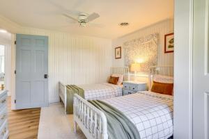 a bedroom with two beds and a ceiling fan at Scenic Waterfront Home with Dock on Lake Winola! in Factoryville