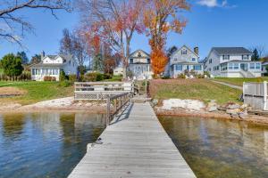 a wooden bridge over a body of water with houses at All-Season Getaway on Lake Winola Dock and Sunroom! in Factoryville