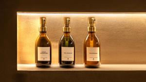 three bottles of wine sitting on a shelf at Cenote Suite - Expérience sensorielle in Le Havre