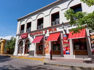 a store with red awnings on a city street at Acogedor Loft en centro histórico - Depa #2 in Isla Cardones