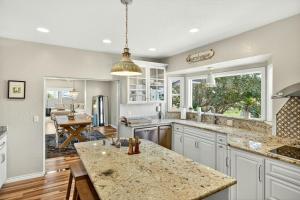 a kitchen with white cabinets and a large island at Meadowsweet Farm- Sleeps 18, Outdoor Kitchen in Talent