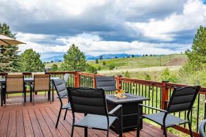 a patio with chairs and a table on a deck at Modern Home with Mountain Views in Missoula