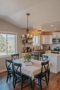 a kitchen and dining room with a table and chairs at Modern Home with Mountain Views in Missoula +15 photos