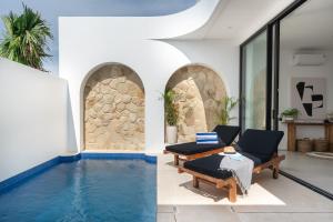 a villa with a pool and a living room at Elements Villa B1 - Rooftop, Pool & 5-Min to Beach in Bingin Beach