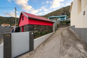 a red building on the side of a road at Casa Joao Batista em Machico in Machico