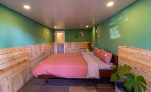 a bedroom with a bed in a room with green walls at Dalat inn homestay hẻm 48 hà huy tập in Teurnoum +40 photos