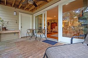 a screened in porch with a table and chairs at SG6A: 6A Seagrove Villa in Isle of Palms
