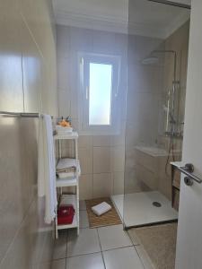 a bathroom with a shower and a toilet and a sink at Casa da Cruz in Porto da Cruz +24 photos