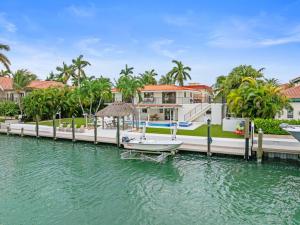 a house on the water with a boat on a dock at Deep Blue Waterfront Gem Pool Kayaks Dock in Key Colony Beach