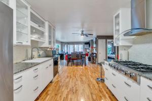 a kitchen with white cabinets and a wooden floor at Capitol Retreats-views! Near Salt Palace,sleep 28 in Salt Lake City