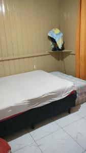 a hospital room with a bed and an umbrella at Casa de Veraneio in Passo De Torres