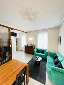 a living room with a couch and a table at La Maison du Bonheur - 10 people - Close to Paris in Noisy-le-Grand