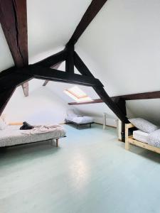 a room with two beds in a attic at La Maison du Bonheur - 10 people - Close to Paris in Noisy-le-Grand