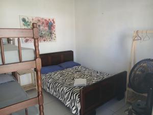 a bedroom with a bunk bed and a ladder at Pousada Costeira Barra do Sul in Balneario Barra do Sul