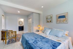 a bedroom with a large bed and a chair at Boat Dock and Patio Canal-Front St James City Home! in Saint James City
