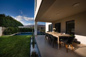 a dining table and chairs on the patio of a house at Moonlight City Villa in Alba Iulia