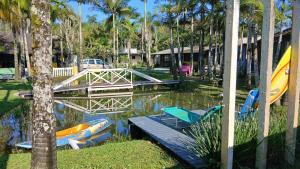 a group of boats in the water with a bridge at Pousada Costeira Barra do Sul in Balneario Barra do Sul