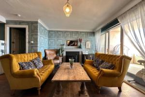 a living room with two couches and a table at Dog-friendly Seaview Apartment in Dungarvan