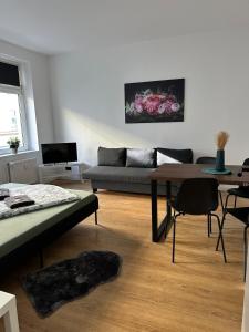 a living room with a couch and a table at Modern Living Leipzig - Wohnung in Lindenau in Niederdorla