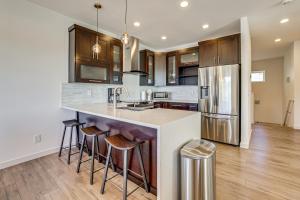 a kitchen with a large island with bar stools at 4 Mi to Dtwn Greenville Group-Ready Home with Yard in Piedmont Park