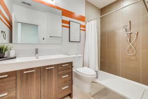 a bathroom with a sink and a toilet and a shower at 4 Mi to Dtwn Greenville Group-Ready Home with Yard in Piedmont Park +20 photos