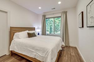 a white bedroom with a bed and a window at 4 Mi to Dtwn Greenville Group-Ready Home with Yard in Piedmont Park