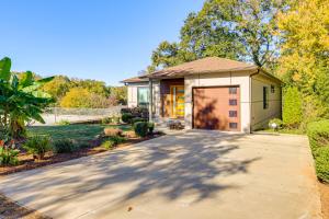 a house with a garage and a driveway at 4 Mi to Dtwn Greenville Group-Ready Home with Yard in Piedmont Park