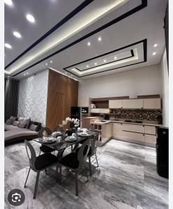 a living room with a dining table and a kitchen at Konohagakure in Jakarta