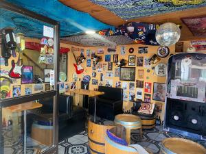 a restaurant with a bar with a lot of pictures on the wall at Hostal Centro in Pichilemu