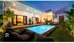 a house with a swimming pool in the yard at Konohagakure in Jakarta