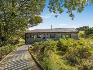 a wooden walkway leading to a stone house at 1 Bed in Llandrindod Wells 53194 in Llandrindod Wells