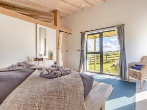 two beds in a room with a large window at 1 Bed in Llandrindod Wells 53194 in Llandrindod Wells