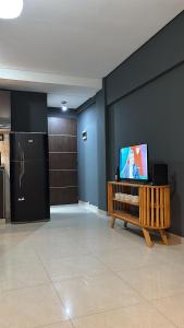 a living room with a television on a table at Ballester apart piscina in Villa Ballester