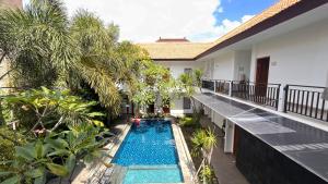 ein Balkon mit Swimmingpool in einer Villa in der Unterkunft The Baliem Hotel in Jimbaran