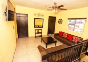 a living room with a couch and a ceiling fan at Rocky Point Casa Mango w Pool Walk to Beach in Ciudad Constitución