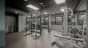 a gym with several tread machines in a room at Astral Desert Retreats in Mesa