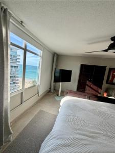 a bedroom with a bed and a view of the ocean at Stylish Designed 1BR Coral Beach by Stay Here PR in San Juan +17 photos