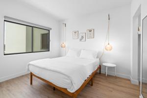 a white bedroom with a bed and a window at Astral Desert Retreats in Mesa +21 photos